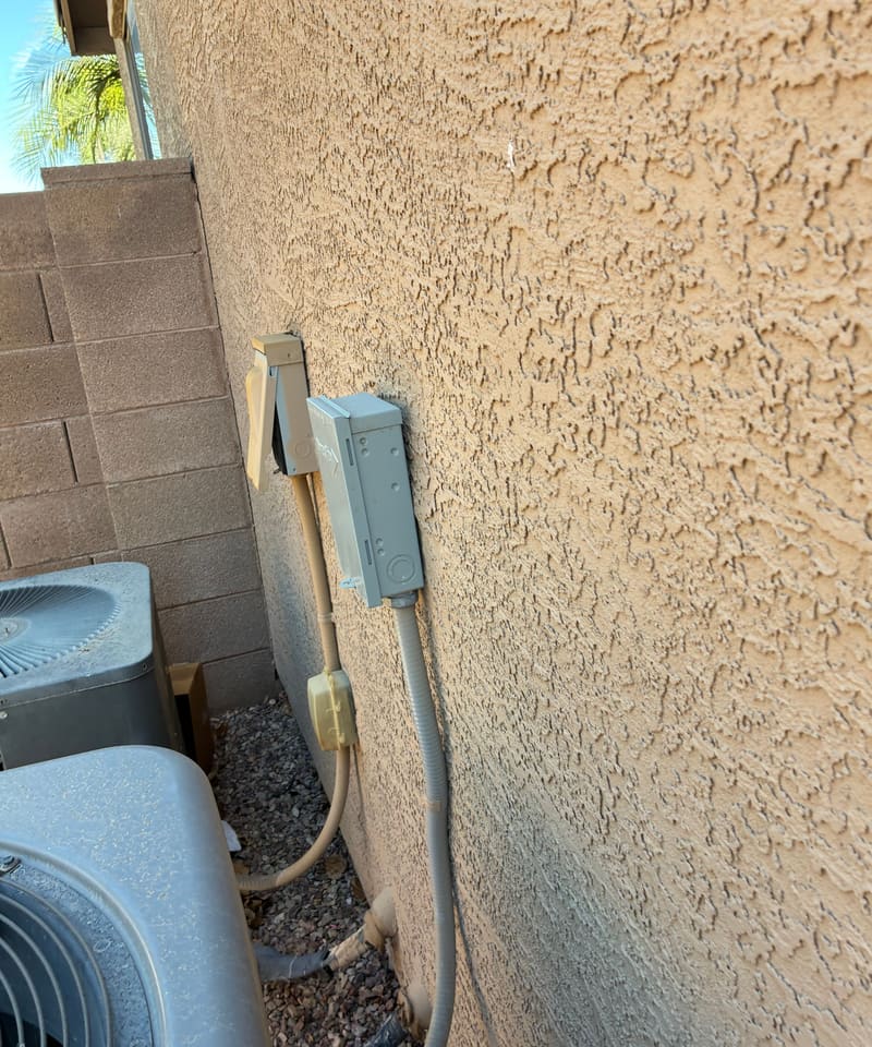 Side yard with an AC unit and conduit running along the wall, a common pest path.